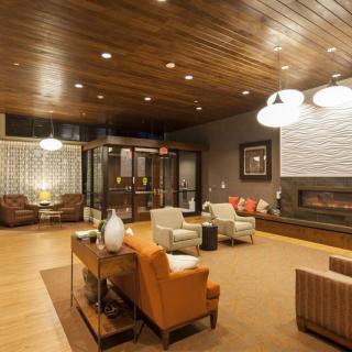 A modern living room with warm wooden accents and cozy lighting.