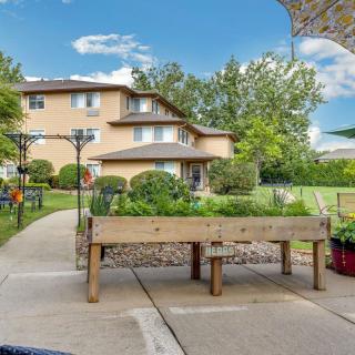 A spacious backyard featuring a raised vegetable garden and a multi-story house in the background.