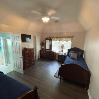 A cozy bedroom with twin beds and classic wooden furniture.