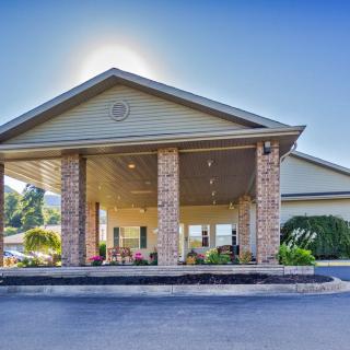 A building entrance with prominent columns and a clear blue sky.