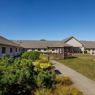 A well-maintained courtyard with pathways and landscaping, surrounded by a single-story building.
