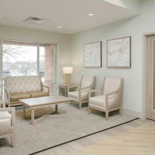 A bright and modern living room featuring comfortable seating, a coffee table, and artwork on the walls.