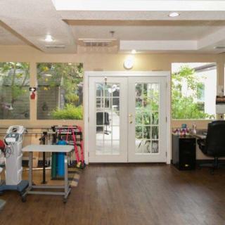 Bright room with a sewing workstation, French doors, and large windows providing natural light.