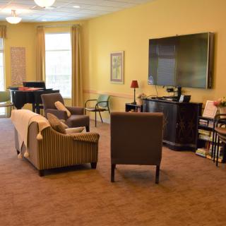 A cozy living room with comfortable seating and a large television.