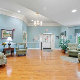 A well-furnished lobby with elegant seating, soft lighting, and decorative plants.