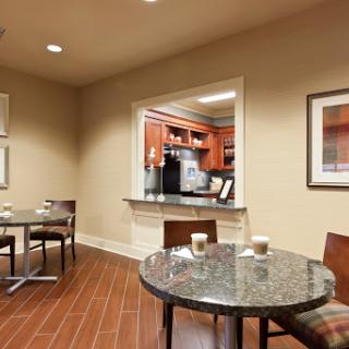A cozy reception area featuring a granite table and warm wooden accents.