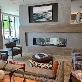 A modern living room with a sleek fireplace and comfortable seating.