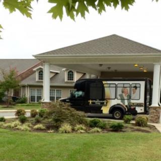A delivery truck parked at the entrance of a commercial building.