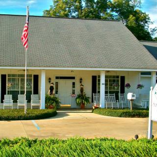 A suburban house with an American flag and a welcoming front porch.