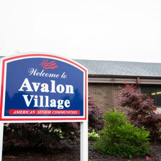 Welcome sign for Avalon Village, an American Senior Community.
