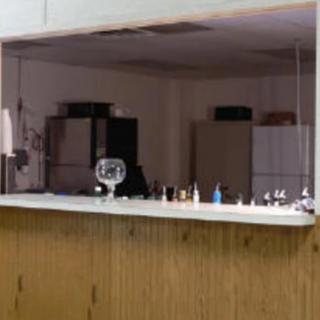 An office reception area with a wooden counter and various items on display.