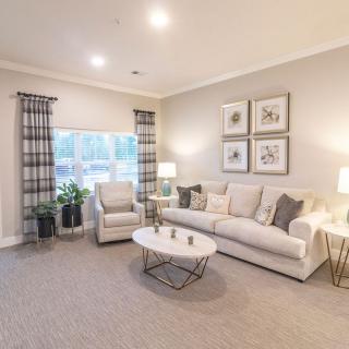 A cozy living room with modern furniture and neutral tones.