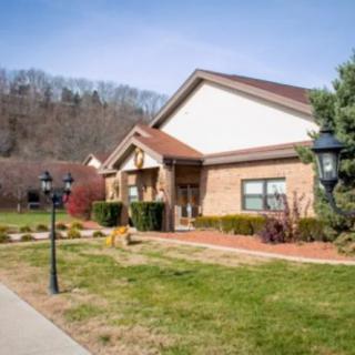 A suburban house with a well-maintained front yard and surrounding landscape.