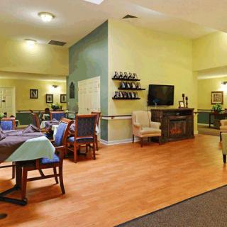 A cozy living and dining area with comfortable seating, a television, and tasteful decor.
