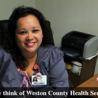 A healthcare professional smiling in an office setting.