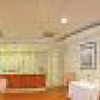 A spacious room with modern decor and a wooden floor.