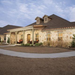 A beautiful stone-exterior suburban house with a welcoming front porch.