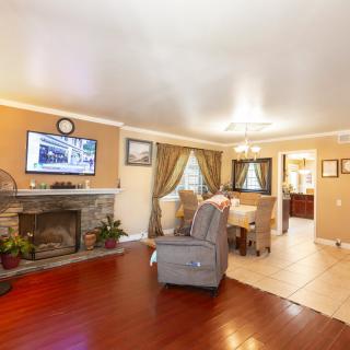 A cozy living room with a fireplace and television, featuring comfortable seating and elegant decor.