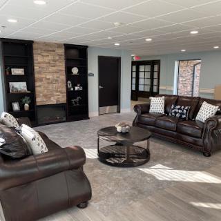 A stylish and modern living room featuring comfortable leather sofas, a contemporary coffee table, and beautiful decor.