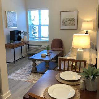 A cozy living and dining area with a warm lighting ambiance.