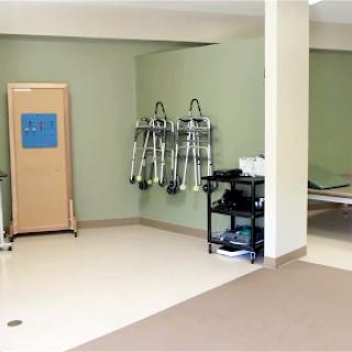 A well-lit therapy room equipped with medical tools and a reception area.