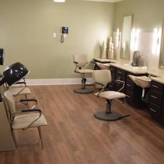 Interior view of a hair salon with chairs and mirrors.