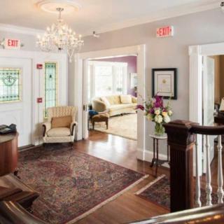 A sophisticated lobby with elegant furnishings and a chandelier.