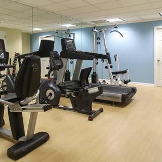 A well-equipped gym with various exercise machines.