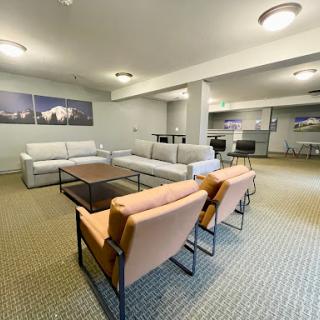 A spacious and modern lounge area featuring comfortable seating arrangements.