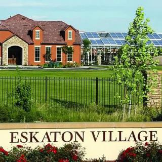 A view of Eskaton Village featuring a residential house and a well-maintained landscape.