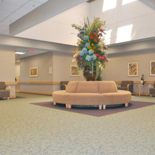 A spacious and well-decorated lobby with comfortable seating and floral arrangements.