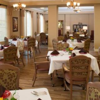 An elegant dining room with neatly arranged tables and chairs.