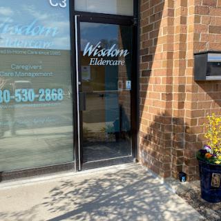 The entrance to a business, featuring a glass door and a stylish sign.