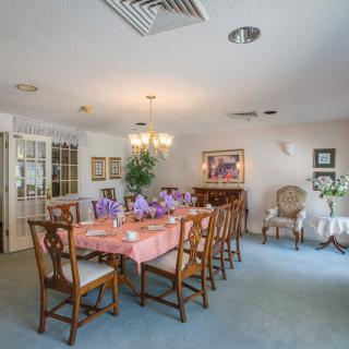 A beautifully set dining room with a large table and elegant furnishings.