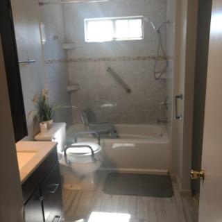 A clean and modern bathroom with a bathtub and vanity.