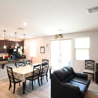 A modern open-concept living and dining area featuring stylish furniture and ample natural light.