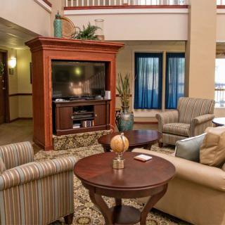 A cozy living room setup featuring a large television, comfortable seating, and stylish decor.