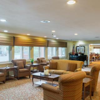 Spacious living room with comfortable seating and large windows.