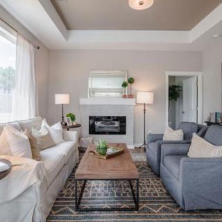A modern living room with comfortable seating and a cozy fireplace.