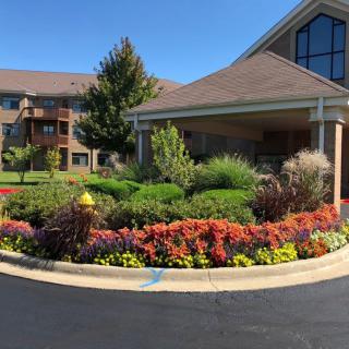 A beautifully landscaped garden in front of a large, modern building.