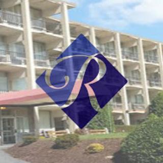 A modern hotel building featuring the logo of the establishment.