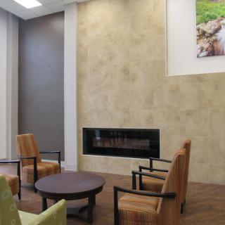 A cozy modern living room featuring comfortable seating and a stylish fireplace.