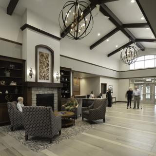 A modern and elegantly designed lobby with comfortable seating and decorative chandeliers.