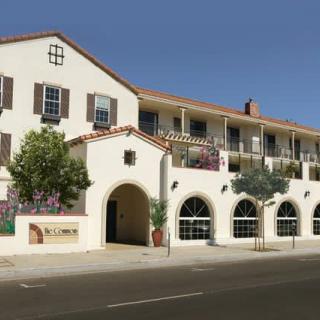 A Mediterranean-style building with balconies and arched windows, likely a hotel.