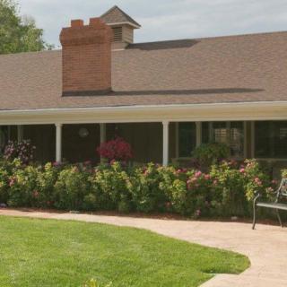 A charming house with a well-maintained garden and inviting porch.