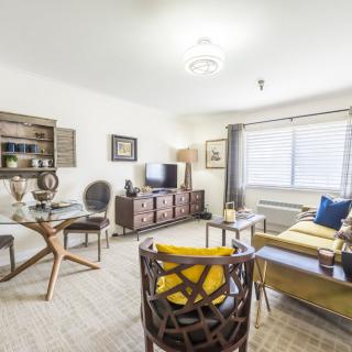 A modern living room with stylish furniture and warm lighting.