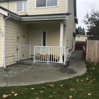 Residential house with a small front porch and driveway.