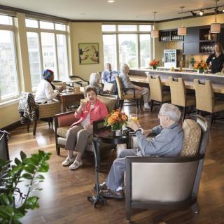 A cozy lounge with people socializing and enjoying beverages.