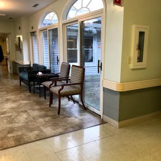 A welcoming indoor lobby featuring comfortable chairs and large windows that invite natural light.