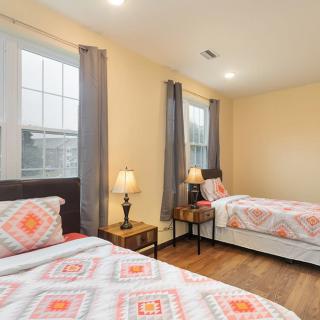A cozy bedroom with two twin beds and warm lighting.
